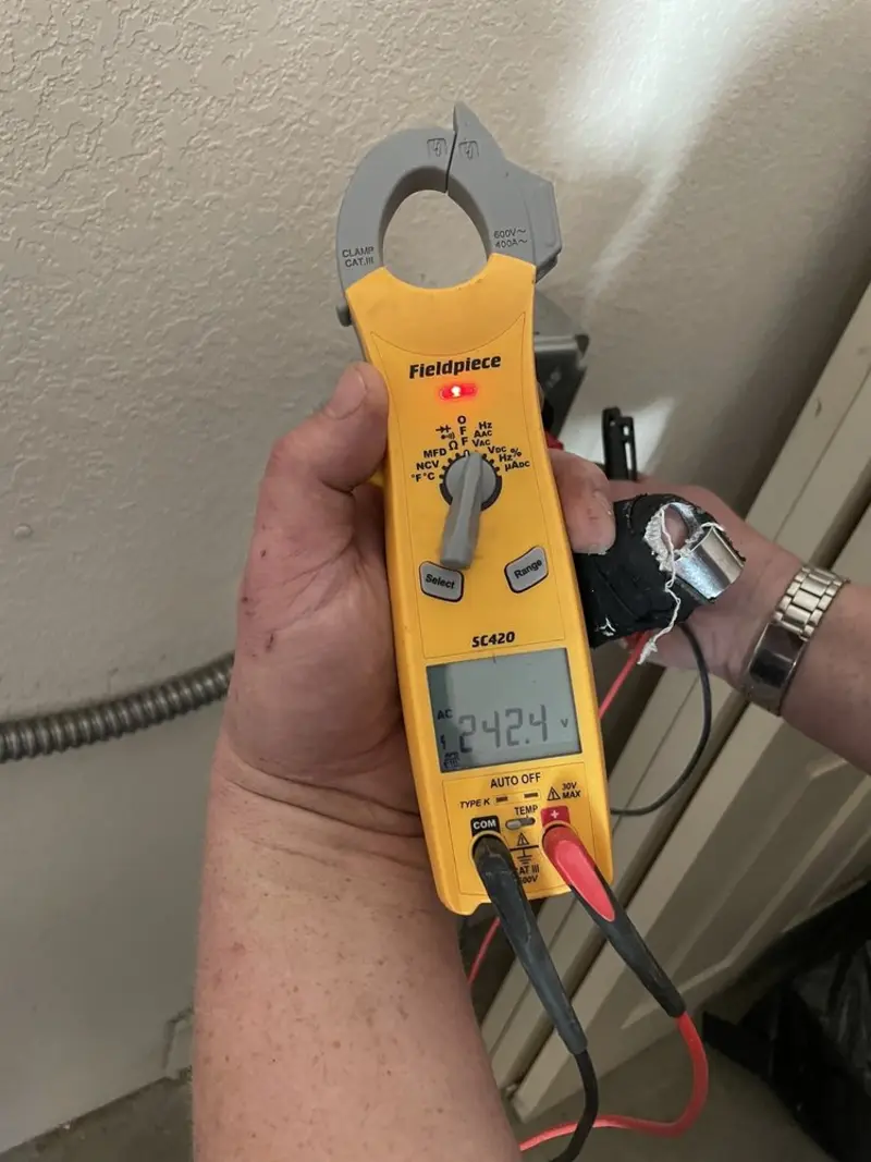 Voltage testing with clamp meter during Electrical Installation Services in Barnstead